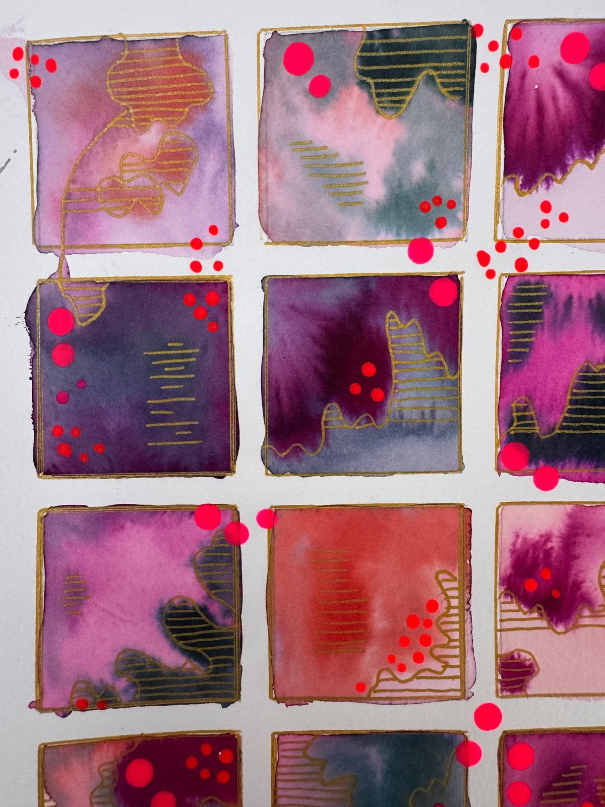 Watercolour painting of fifteen magenta, plum, coral and slate squares in a grid, each outlined in gold, with gold-striped contour shapes and bright pink dots.