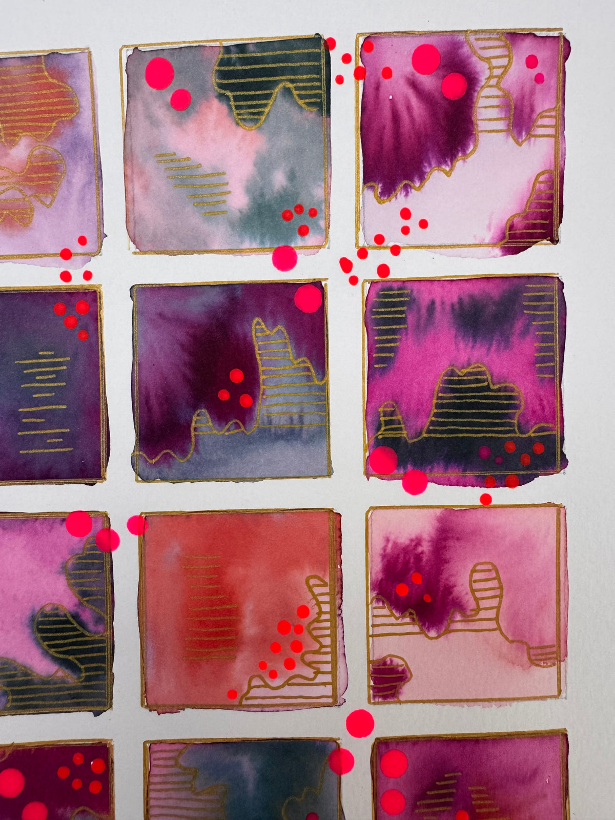 Watercolour painting of fifteen magenta, plum, coral and slate squares in a grid, each outlined in gold, with gold-striped contour shapes and bright pink dots.