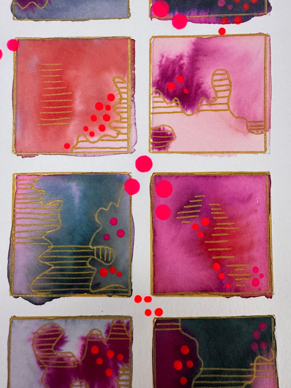 Watercolour painting of fifteen magenta, plum, coral and slate squares in a grid, each outlined in gold, with gold-striped contour shapes and bright pink dots.