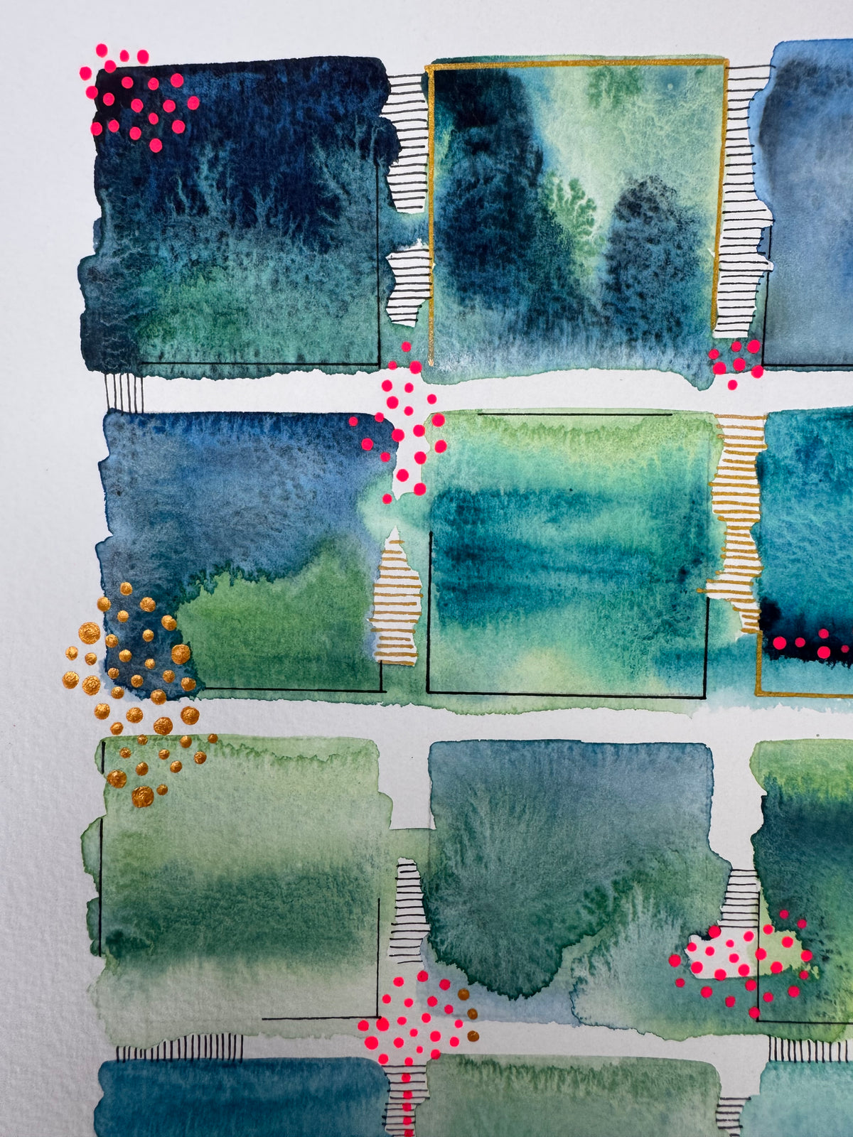 Watercolour painting of fifteen green, teal and blue squares in a loose grid with soft bleeding edges, fine black corner lines, two gold-edged squares, and clusters of bright pink and gold dots.